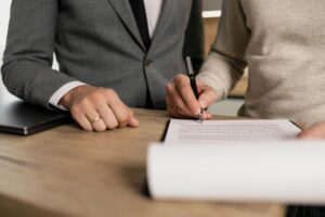 people signing paperwork