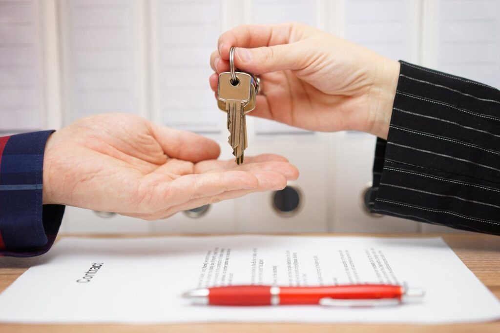 people handing keys to each other with paperwork with the words contract