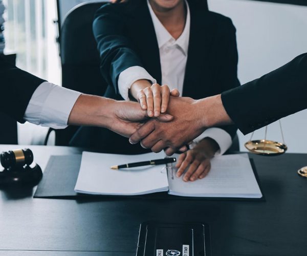 three lawyers with their hands together