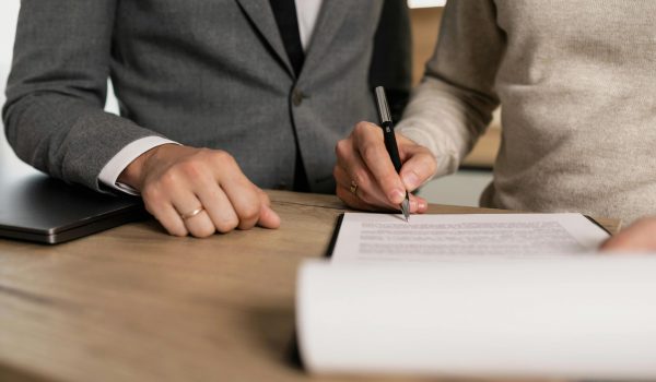 people signing paperwork